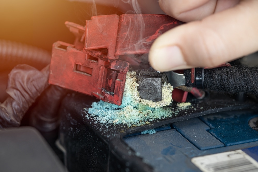 dirty old battery terminal corrosion grunge with green blue ash stuff salt powder at posts contact from acid leak.
