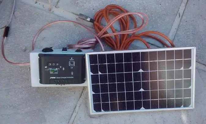 A top view of a solar panel with a battery and wires