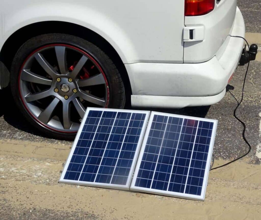 A view of a solar panel placed under a car wheel for charging