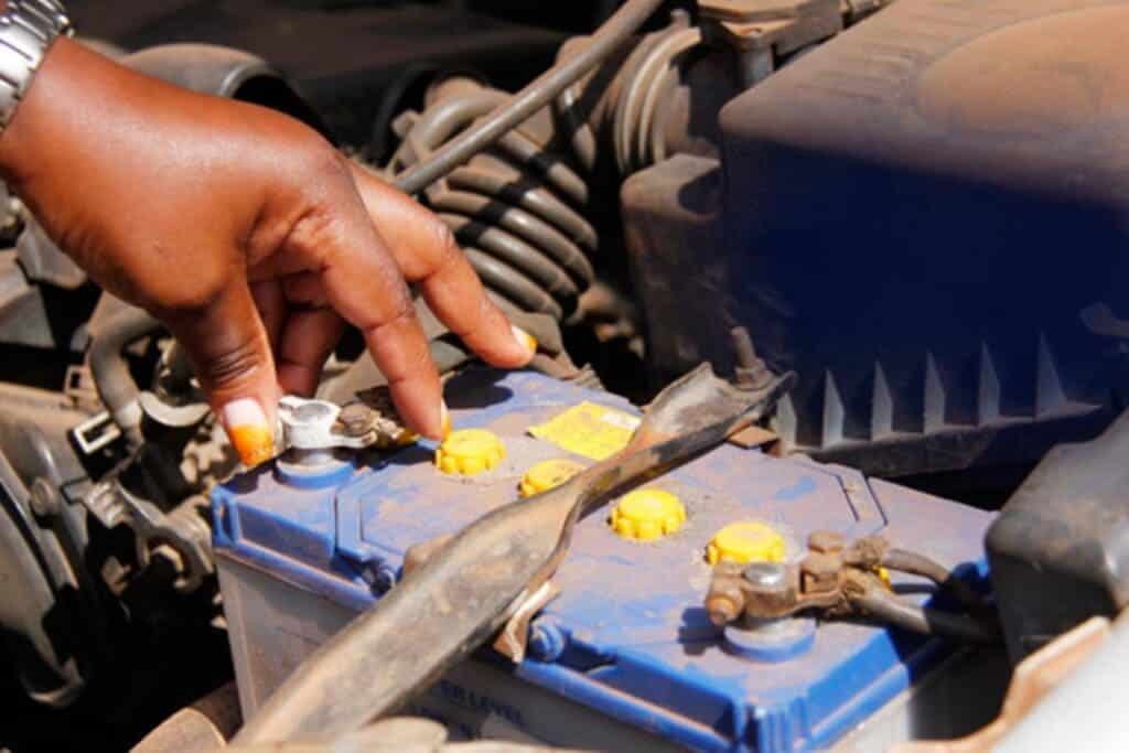 zoomed in view of male hands checking car battery