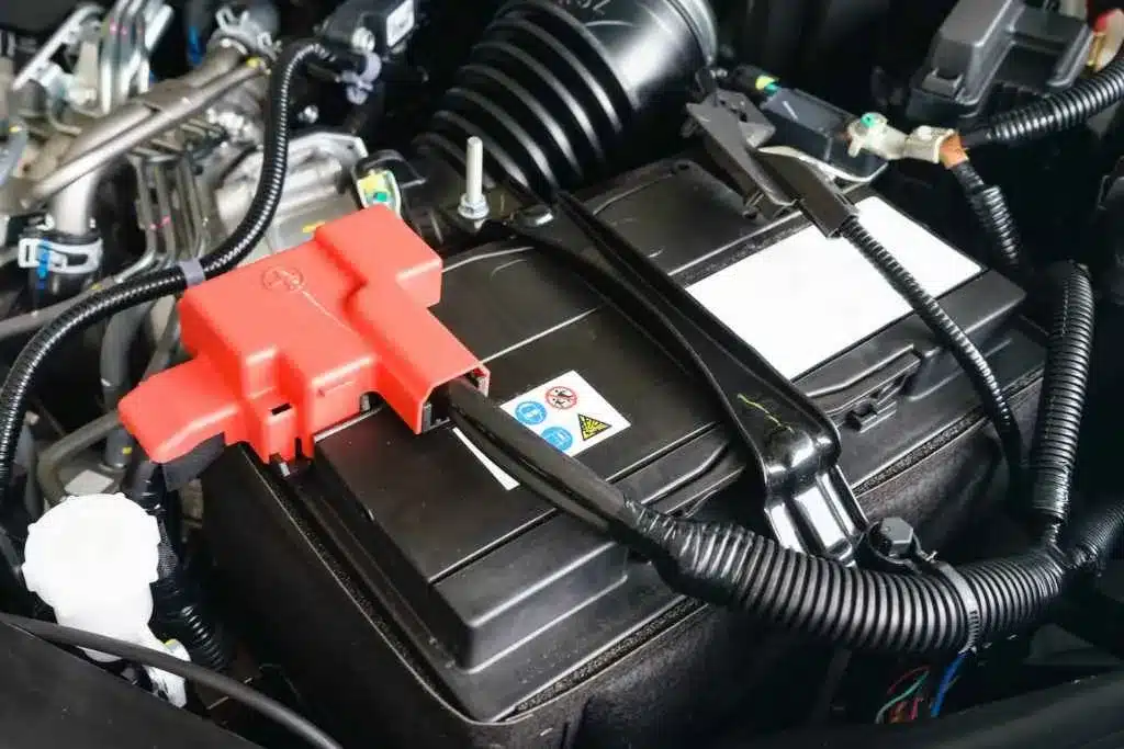 zoomed in view of car battery terminals with red and black wires