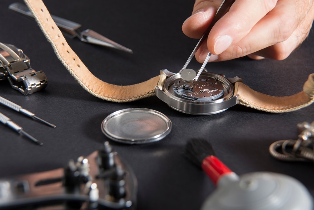 Close Up Of Replacing A Watch Battery With Watchmaker Tools