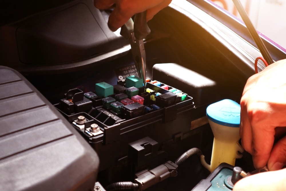 Car Electrical Technician Checking And Repairing Car Fuse Box