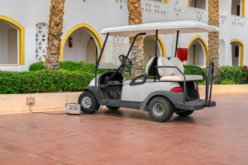 golf cart in a parking lot on charge